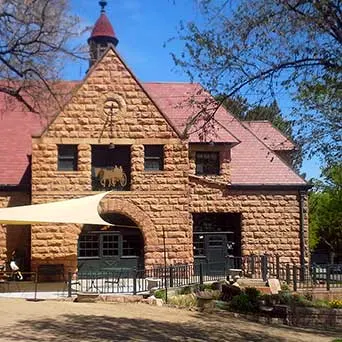 The Carriage House, a stone building with a steep red roof